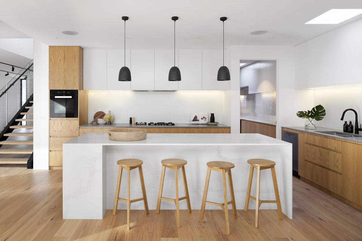 Renovated open-plan kitchen with stone island and timber joinery