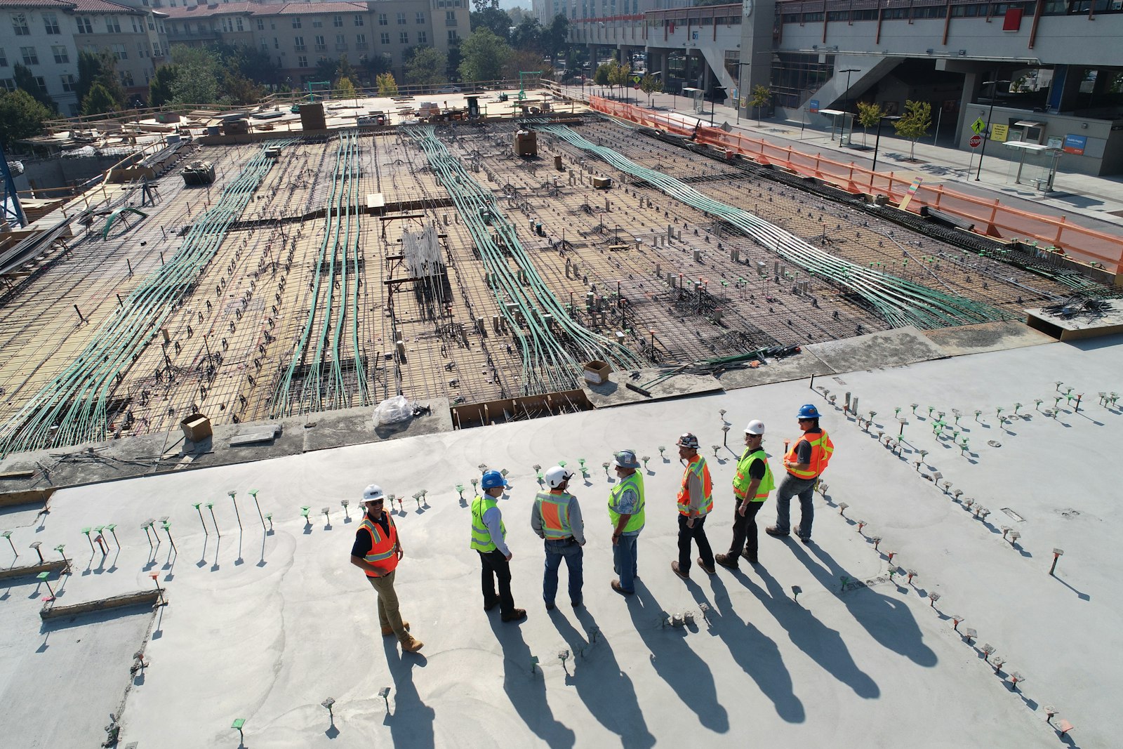 The Test Construction Co team of builders in hard hats and hi-vis on a construction site